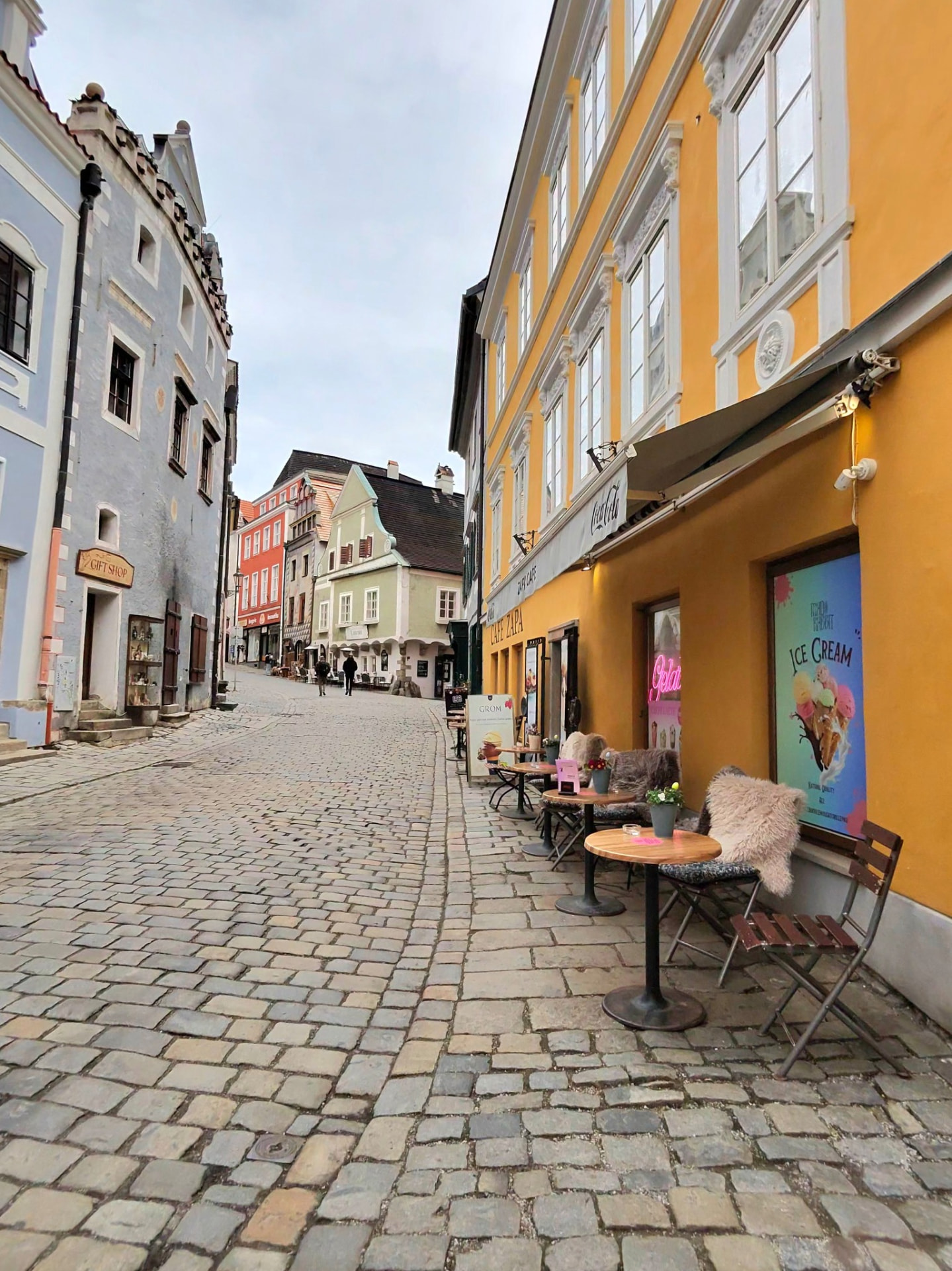 A cobblestone street lined with historic buildings in a European town